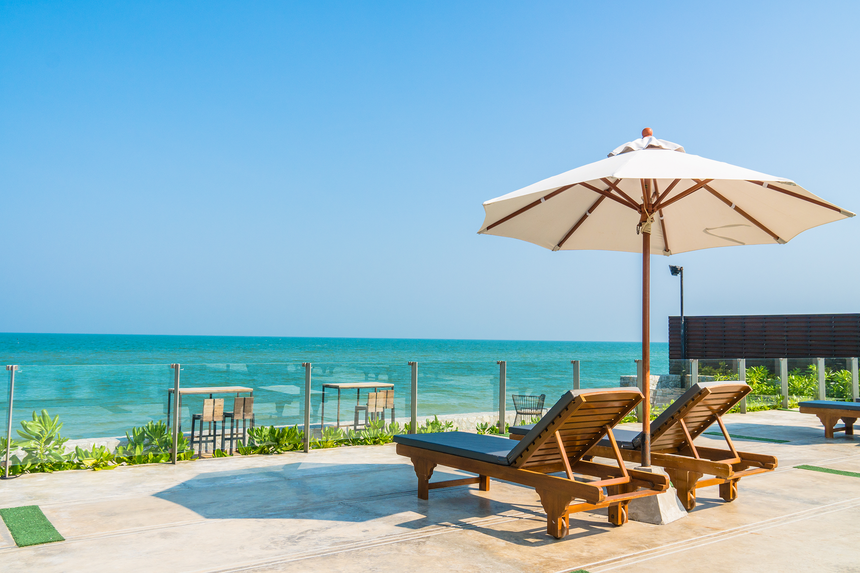 beautiful-umbrella-chair-around-swimming-pool-hotel-resort 1